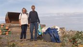 Menno Onnes en vrouw lopen met afvalzakken op Afsluitdijk